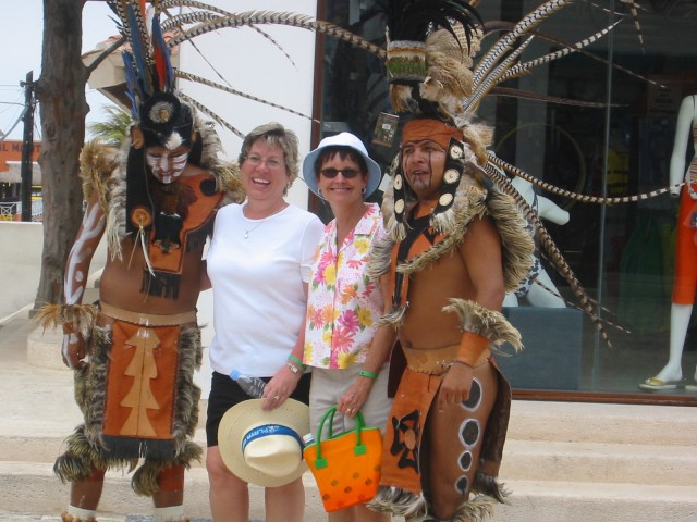 Becky & Wendy with costumed warriors in Playa de Carmen.